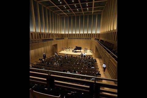 The 420-seat concert hall has a classic shoe-box shape and a grey curtain behind the colonnade to alter the auditorium’s acoustics.